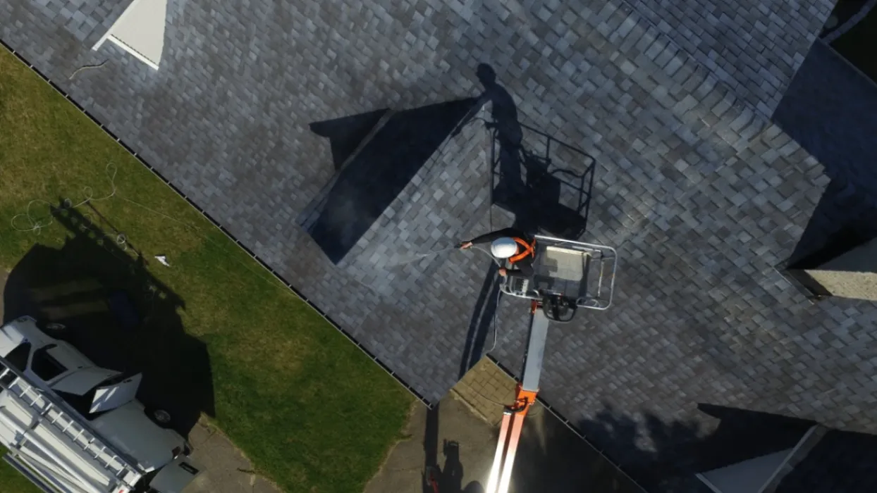 Overhead view of a GoNano treatment being sprayed onto a shingle roof